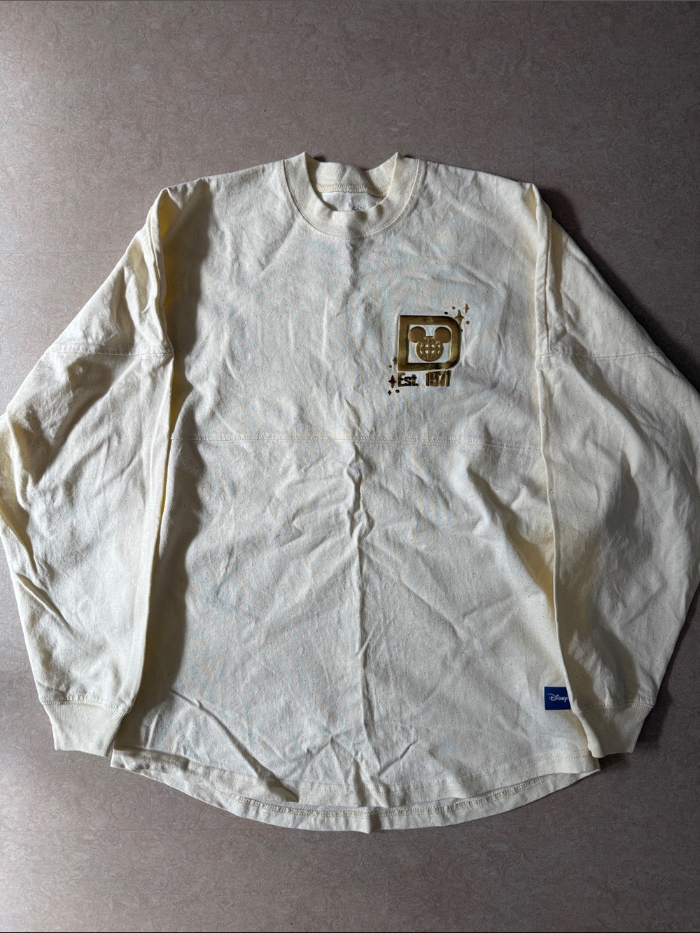 Disney Cream Long Sleeve Graphic Tee with Gold Accent